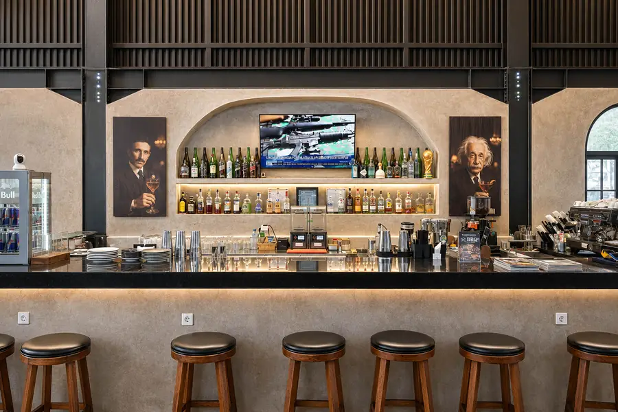 The back bar at Garden Canggu, stocked with spirits under a mounted screen