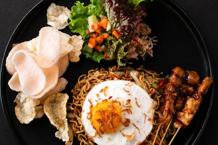 Mie goreng with satay and crackers at Garden Canggu