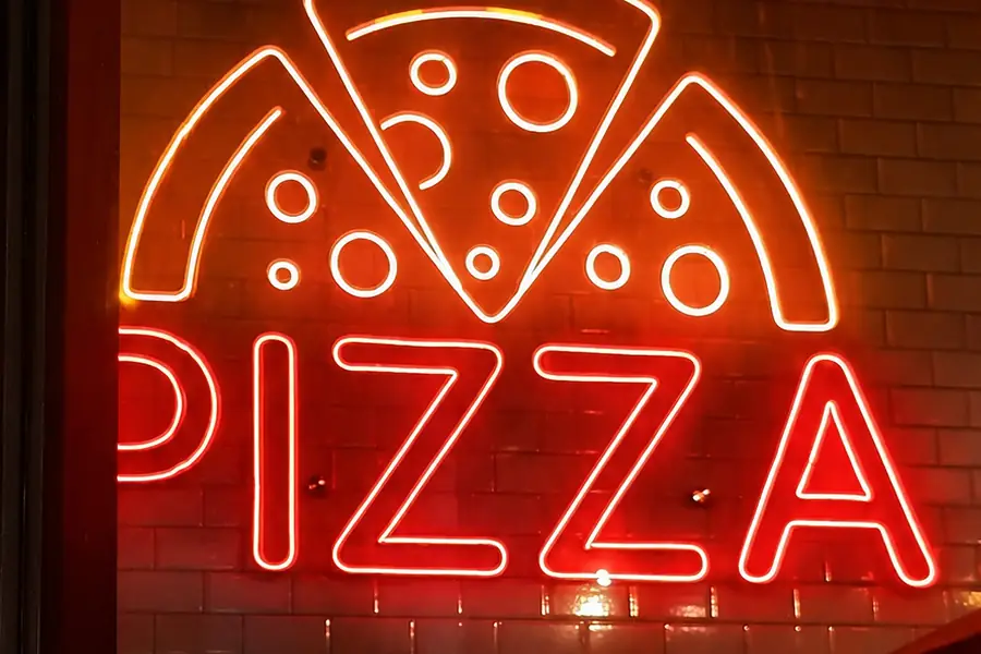 The red neon PIZZA sign at Garden Canggu