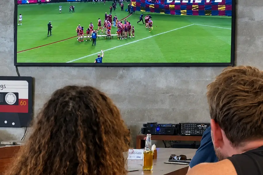 Guests watching a live match on the big screen at Garden Canggu