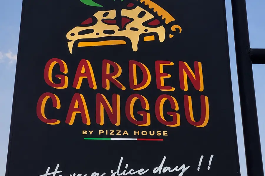 The Garden Canggu sign on Jalan Batu Mejan at dusk