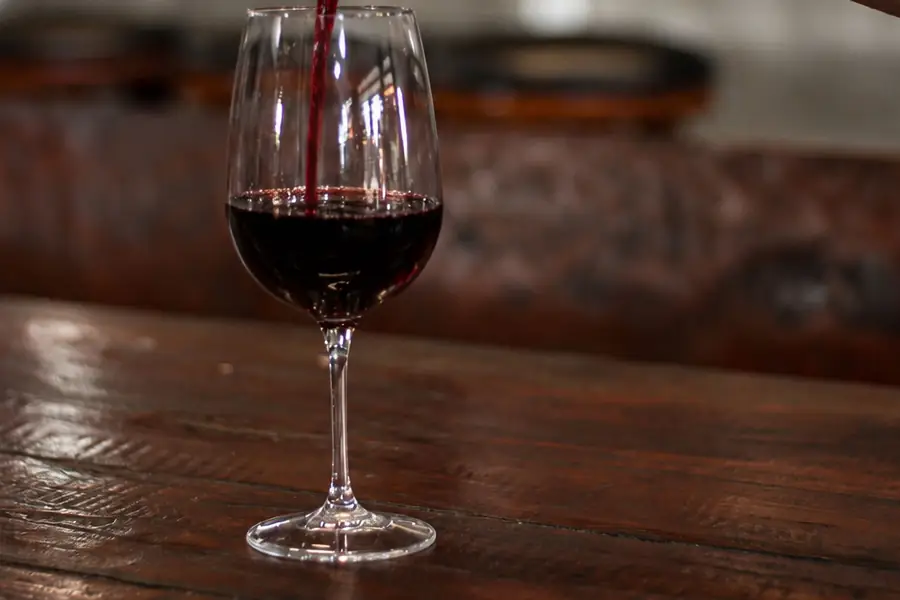 A glass of red wine being poured at Garden Canggu
